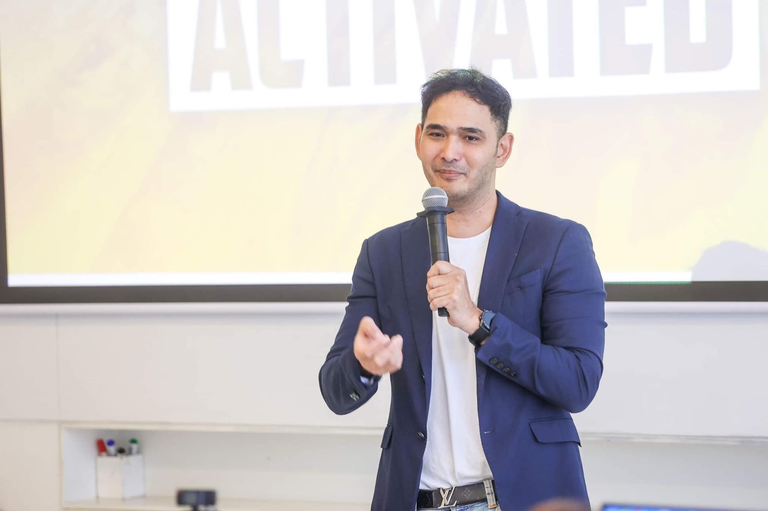 Kris speaking to an audience at an AI seminar